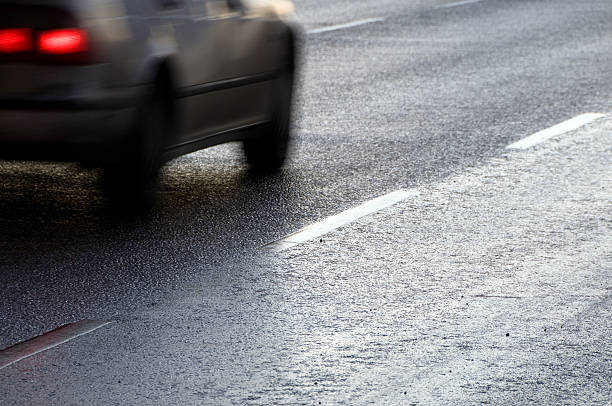 istock Car driving on a reflecting asphalt road 471127797