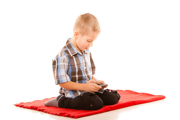 istock Little boy playing games on smartphone 471129168
