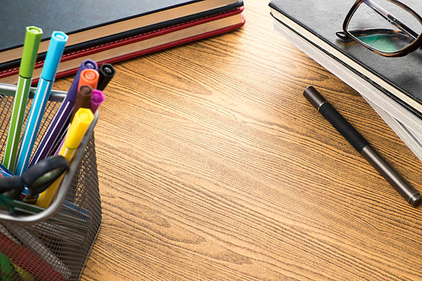 istock education stuff on wooden table.pen ,colour pen ,book 471129324