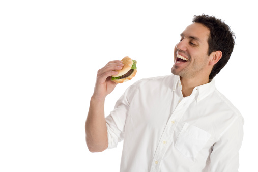 Young smiling man about to eat a healthy hamburger