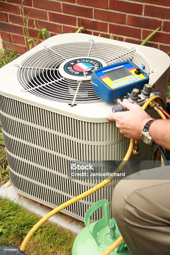 Air Condition Service Air conditioner being serviced. Air Conditioner Stock Photo