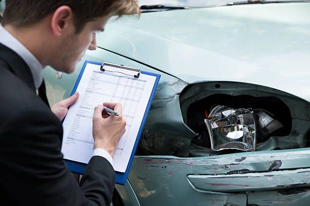 istock Insurance agent examining car after minor accident 471133060