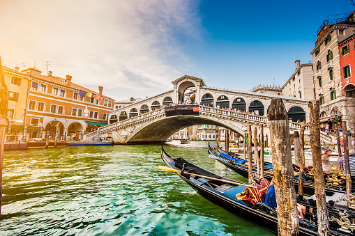 Panoramic view of famous Canal Grande with famous Rialto Bridge at sunset in Venice, Italy with retro vintage Instagram style filter effect.
