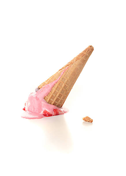 An ice cream cone fallen on the floor stock photo