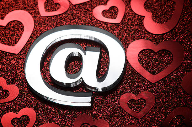 istock At @ Symbol with Hearts on Sparkly Background 471135507