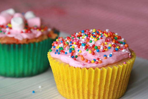 istock Close up of one party cupcake with pink icing sprinkles 471135953