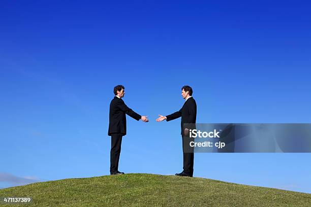 Businessmen Greeting Each Other On A Hilltop Stock Photo - Download Image Now - Abstract, Adult, Adults Only