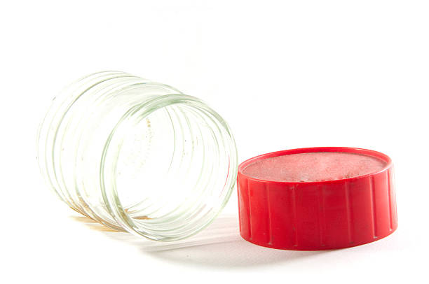 Glass clear empty jam jar and red lid