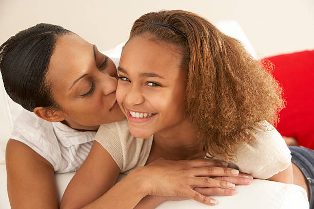 istock Mother And Daughter Relaxing On Sofa 471140959
