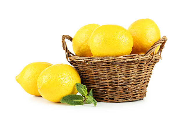 istock Lemons in basket isolated on white 471141142