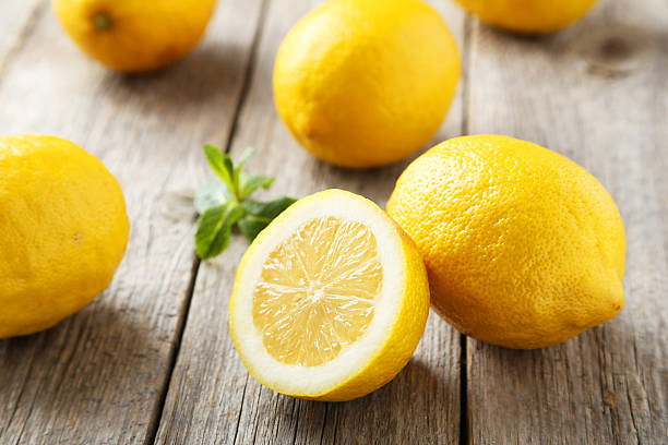 istock Lemons on grey wooden background 471141158
