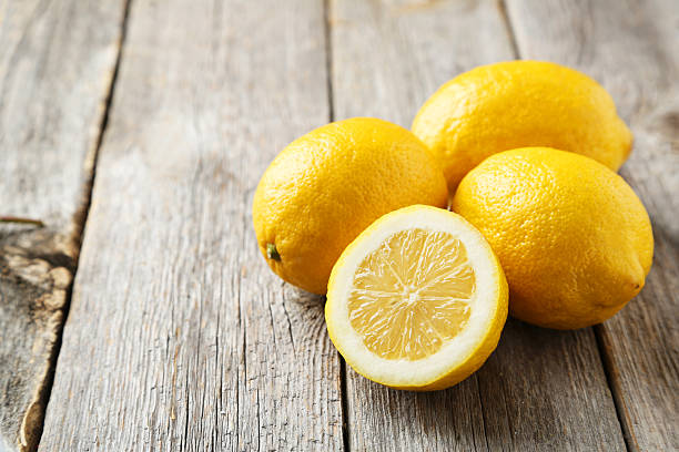 istock Lemons on grey wooden background 471141164