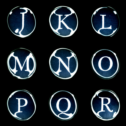 J-K-L-M-N-O-P-Q-R alphabet letters (roman font) isolated on Black background.