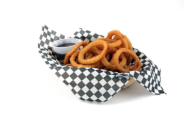 Onion Rings Basket of onion rings with dipping sauce. fried onion rings stock pictures, royalty-free photos & images