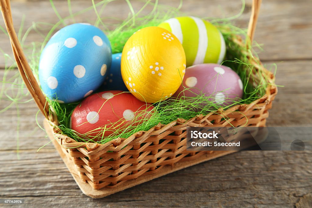 Easter eggs in basket on grey wooden background 2015 Stock Photo