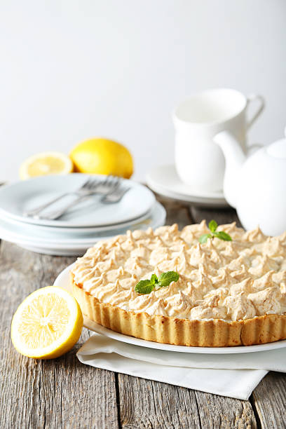istock Lemon meringue pie on plate on grey wooden background 471145038