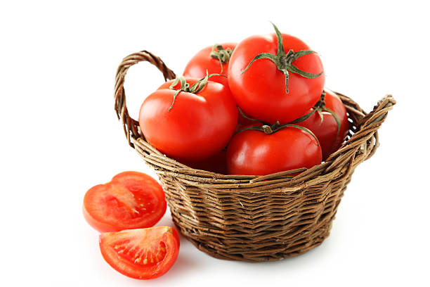 istock Fresh red tomatoes in basket isolated on white 471145058