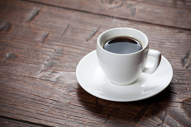 istock Coffee cup and saucer on wooden table 471145136
