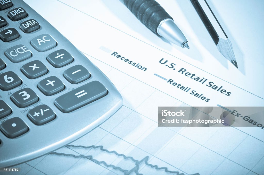 Sales figures A calculator resting upon a growth chart for sales in business 2015 Stock Photo