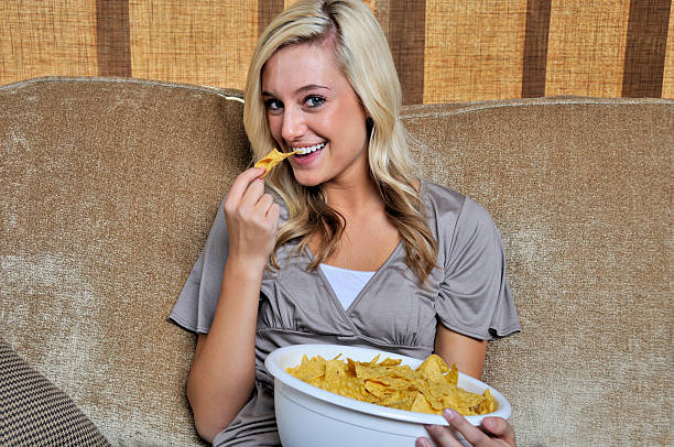 Woman Eating Chips stock photo
