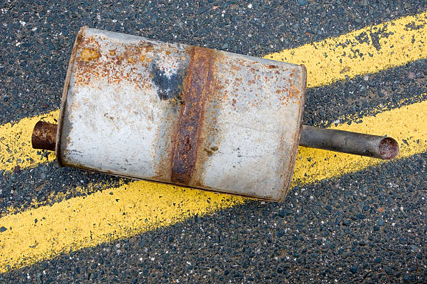 istock Old muffler in the road 471148515