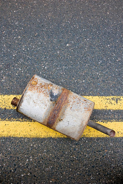 istock Old muffler in the road 471148517