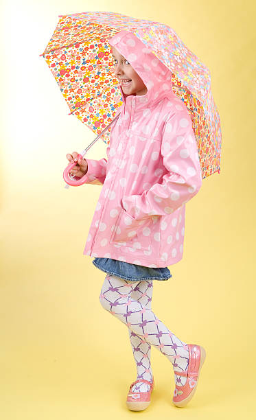 istock shy girl with umbrella 471149101