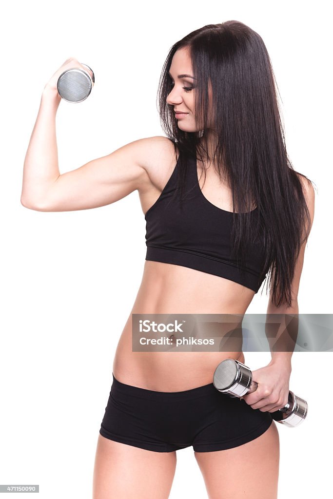 Bellissima giovane donna esercizio nel centro fitness - Foto stock royalty-free di 2015