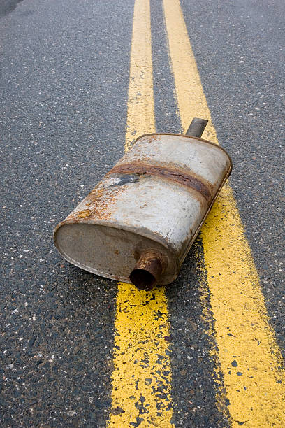 istock Old muffler in the road 471150115