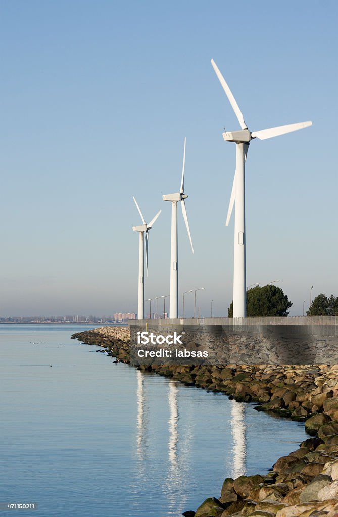 turbines de vent au bord de l'eau, ciel bleu azur. - Photo de Affaires Finance et Industrie libre de droits