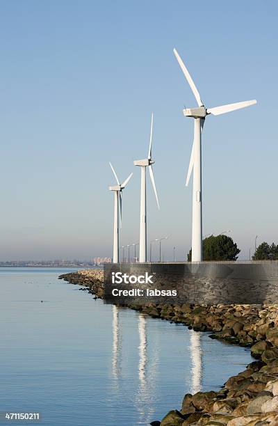 Turbine Eoliche In Riva Al Mare Il Cielo Azzurro - Fotografie stock e altre immagini di Affari finanza e industria - Affari finanza e industria, Ambiente, Composizione verticale