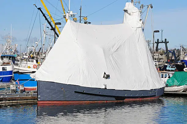 Photo of Fishing boat wrapped in plastic for repair