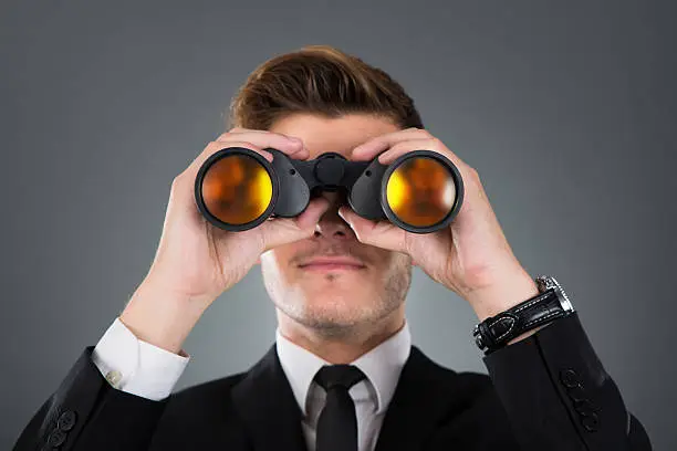 Photo of Businessman Looking Through Binoculars