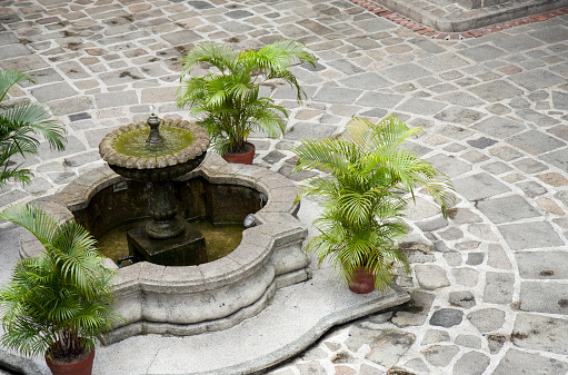 Elegant fountain in the center of small square.
