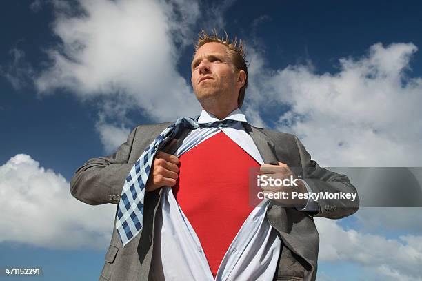 Serious Superhero Businessman Standing Outdoors Against Bright Sky Stock Photo - Download Image Now