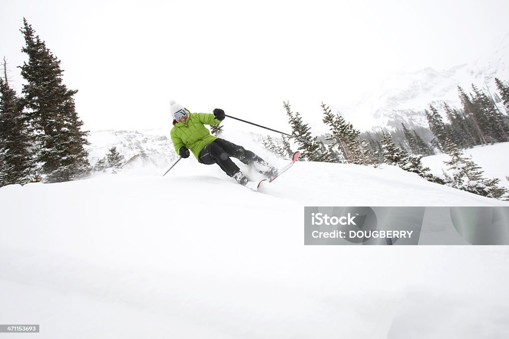 Skiing action Female skier making a turn in fresh snow 30-39 Years Stock Photo