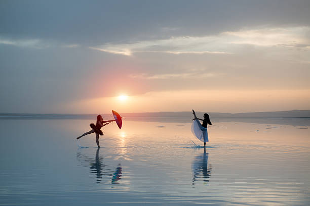 istock Beautiful modern ballet dancer dancing on the lake with tulle 471156112
