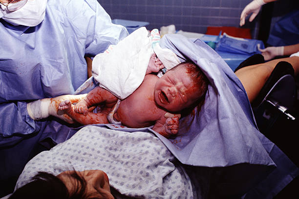 The birth of a child with doctor stock photo