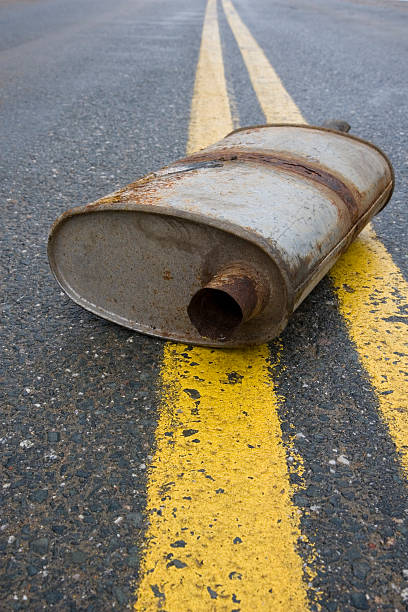 istock Old muffler in the road 471156457