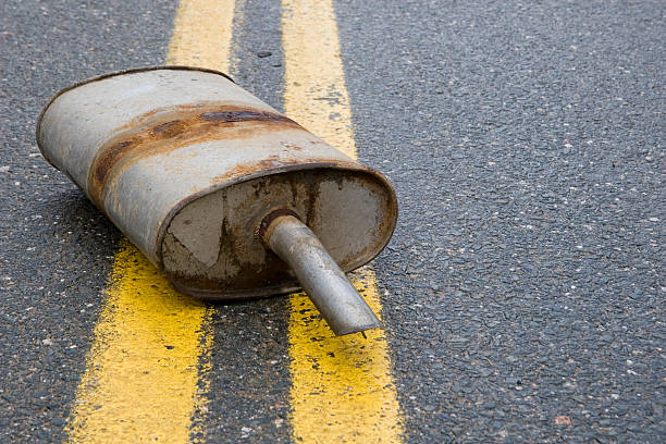 istock Old muffler in the road 471156461