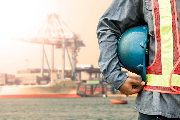istock Harbor dock worker talking on radio with ship background 471158604