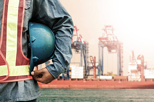 istock Harbor dock worker talking on radio with ship background 471158706