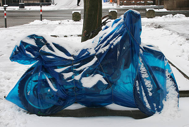 wrapped motorcycle in blue stock photo