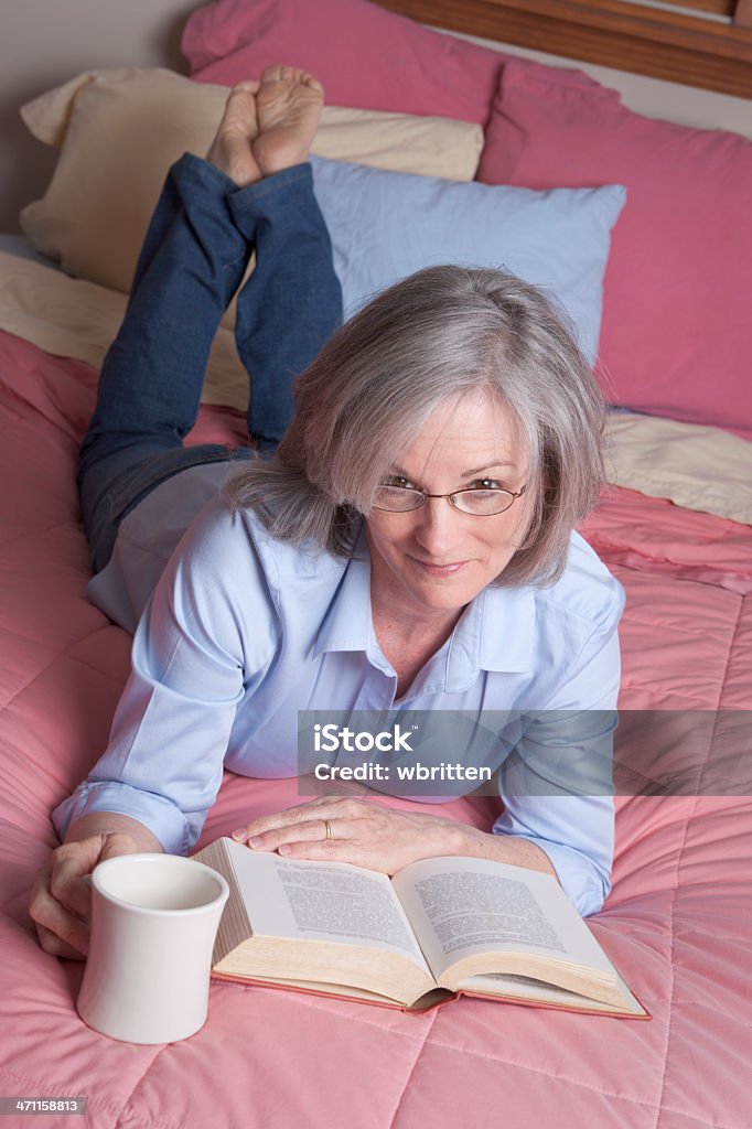 Woman relaxing with coffee and book (XXL) Attractive mature woman in a relaxing, tranquil pose. 40-44 Years Stock Photo