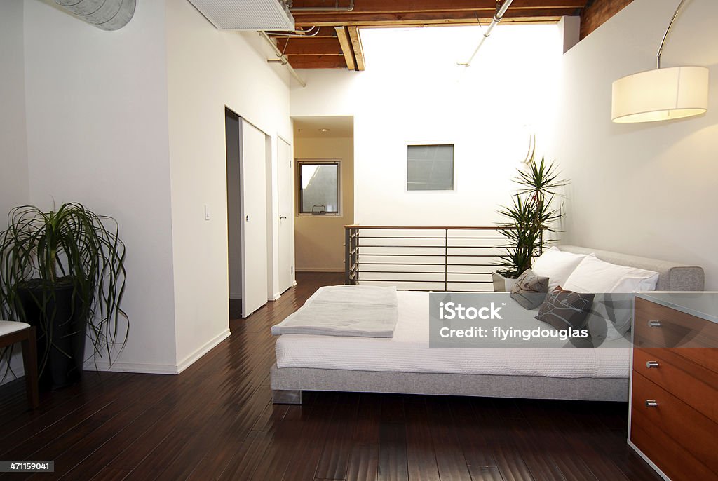 Loft Bedroom An upscale industrial loft with natural light from a sun roof. Feng Shui Stock Photo