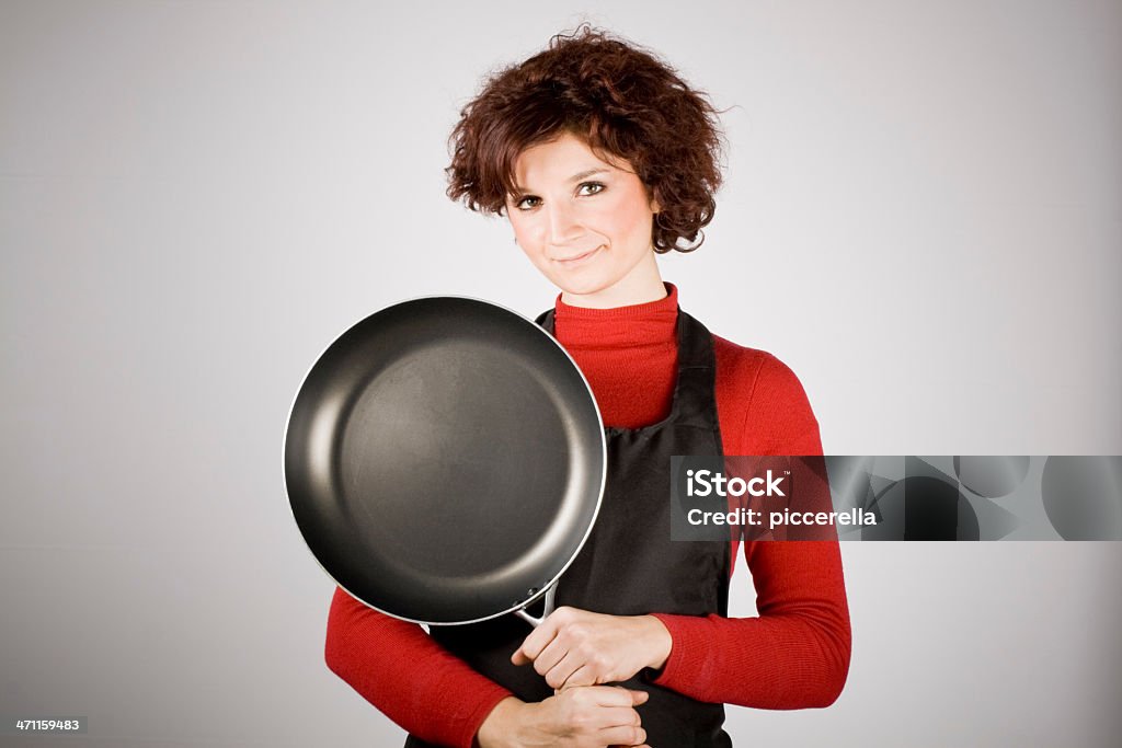 I love to cook! Woman holding an empty frying pan. Cooking Pan Stock Photo