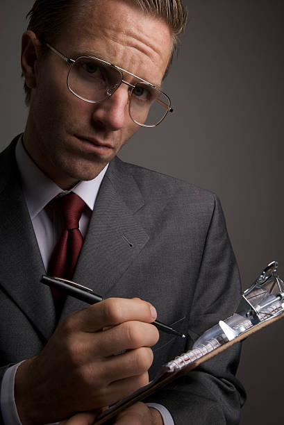 istock Serious Businessman with Glasses Taking Notes on Clipboard 471159847
