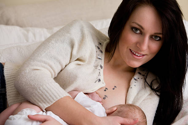 istock young mother nurses infant daughter 471160559