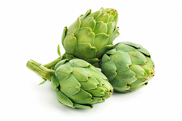 Three green, fresh, raw artichoke vegetables, isolated on a white background. These artichoke hearts of these cultivated garden vegetables are part of a diet for healthy eating.