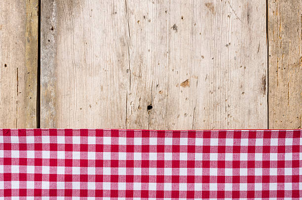 istock Red checkered tablecloth on a rustic wooden background 471161660
